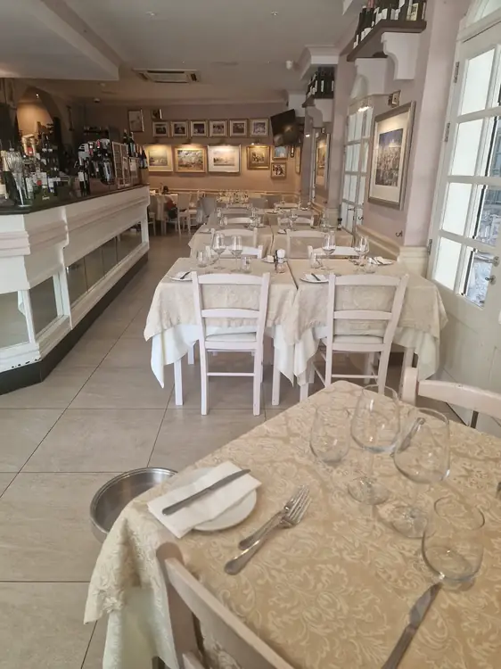Tal-Familja dining area with white table linen